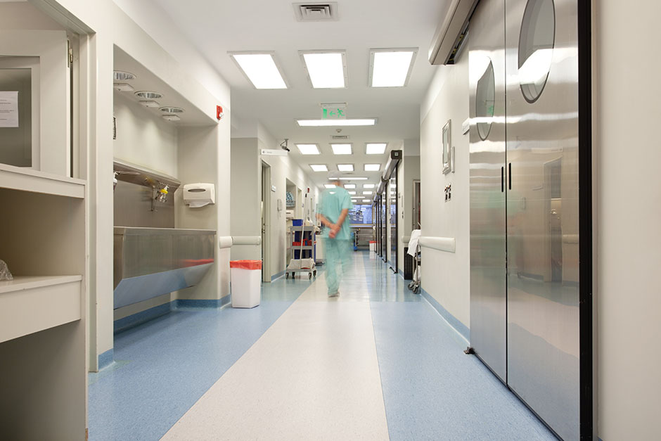 Doctor-walking-through-hospital-corridor.jpg